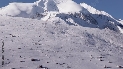 panoramic view of thorung la pass covered by snow during a sunny day himalayan mountains nepal, famous pass at five thousand meters photo