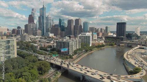 Aerial: Philadelphia city skyline & freeway traffic crossing the Schuylkill River, Pennsylvania, USA