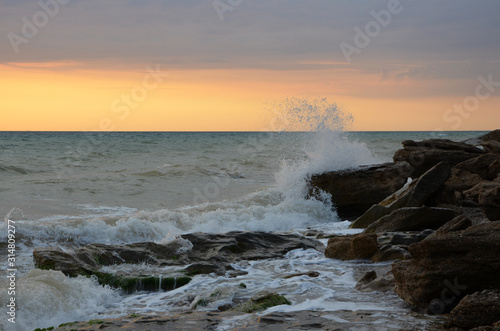 Wave crashing on sea rocky shore