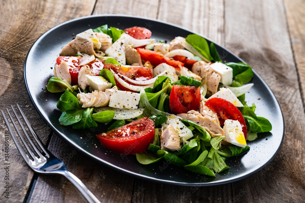 Tasty salad - vegetables , feta cheese and barbecue chicken fillet