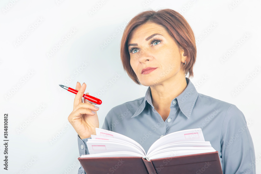 business girl with a red pen and notebook in hands on a white background business girl with a red pen and notebook in hands on a white background