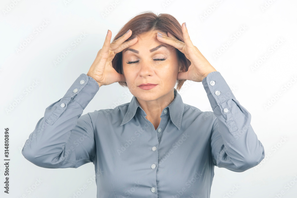 Beautiful young business girl with closed eyes thinks over her project on a white background. thoughts and stress. relaxation and emotions Beautiful young business girl with closed eyes thinks over her project on a white background. thoughts and stress. relaxation and emotions