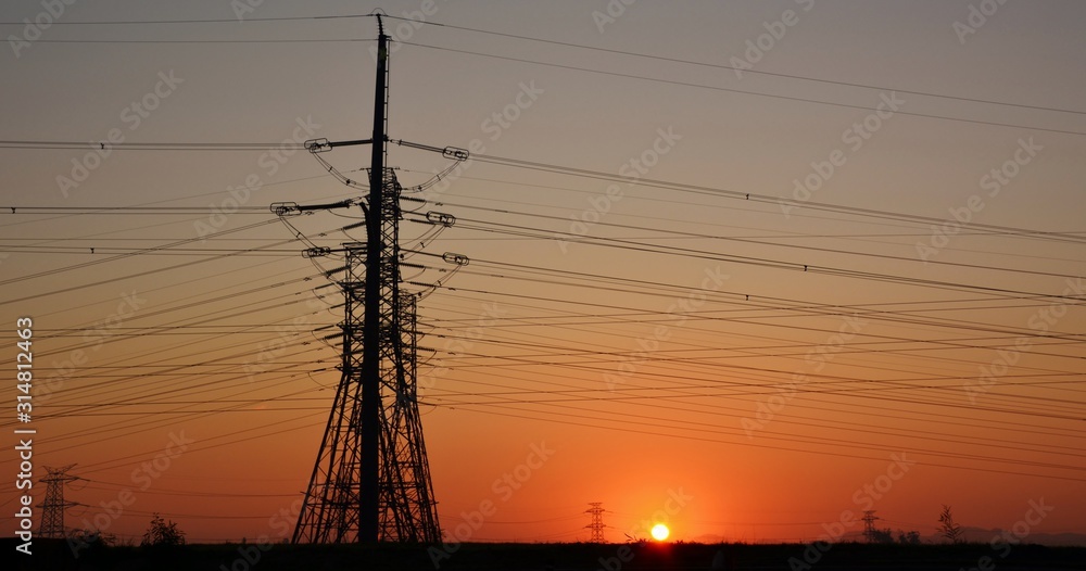 Landscape with power lines at sunrise