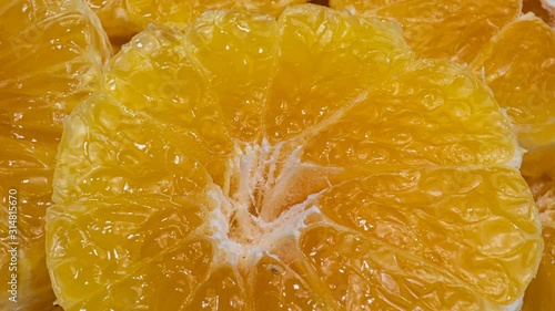 Fresh sweet orange rotating. Extreme macro of juicy tangerine, rich in natural antioxidants. concept of orange fruits, vitamins and natural antioxidants to the skin for beauty. Close up 4k fruit foota photo