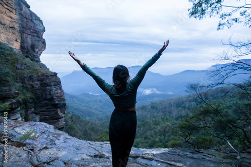 Female doing yoga pose in front of valley at Blue Mountains