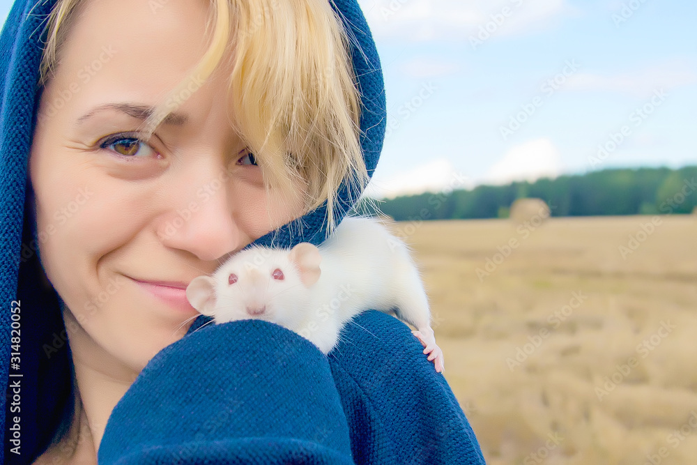 young smiling woman with a cute white rat sitting on her shoulder young smiling woman with a cute white rat sitting on her shoulder