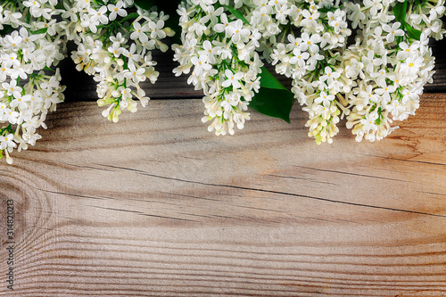 The beautiful lilac on a wooden surface.