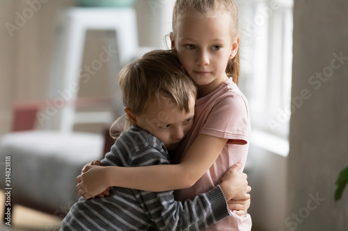 Papier peint Small children brother and sister hug showing love
