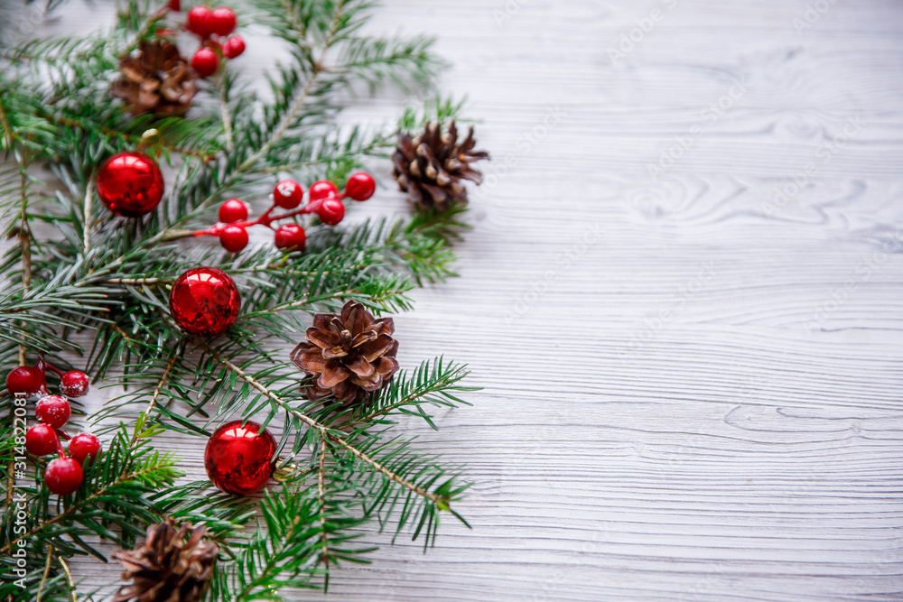Christmas background with xmas tree and red berries on white wooden background. Merry christmas greeting card, frame, banner. Winter holiday theme. Happy New Year. Space for text.