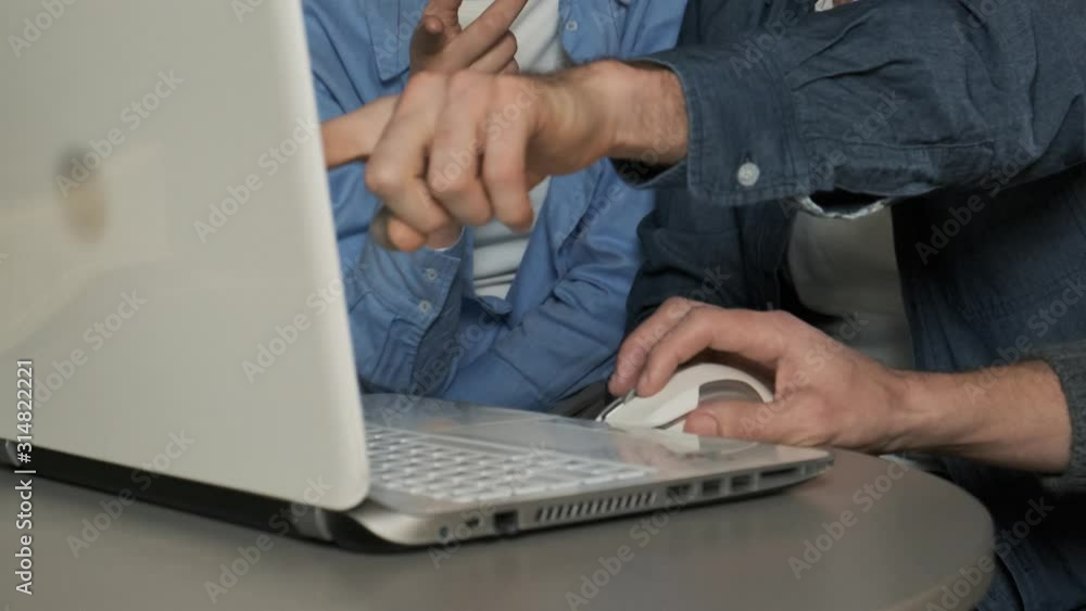 The designer shows an interior project on a laptop in a meeting with a young couple. Young family chooses interior design. Slow motion 4k The designer shows an interior project on a laptop in a meeting with a young couple. Young family chooses interior design. Slow motion 4k