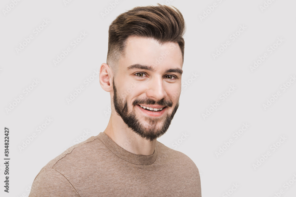 Closeup portrait of handsome smiling young man. Laughing joyful cheerful men studio shot. Isolated on gray background - obrazy, fototapety, plakaty 