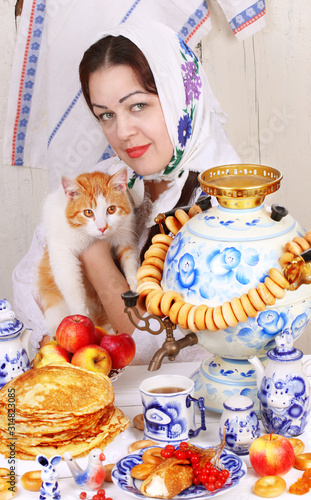 The girl holds a red cat in her arms. Maslenitsa