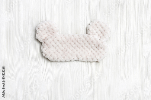 Eye mask for sleeping made of fluffy faux fur on white background. View from above