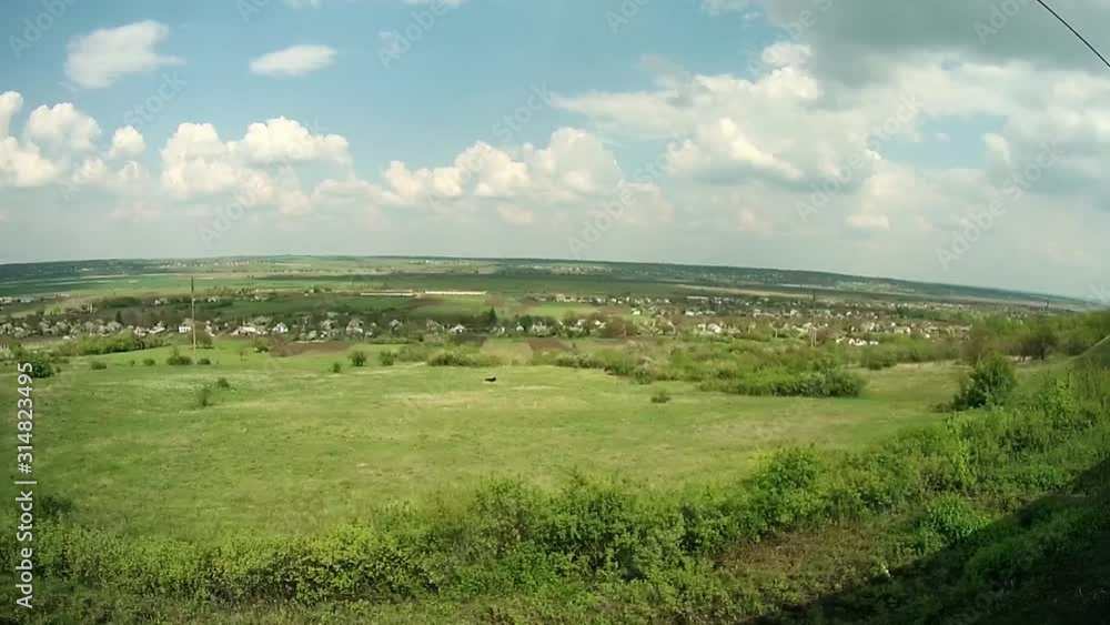 train rides past a valley with a village train rides past a valley with a village