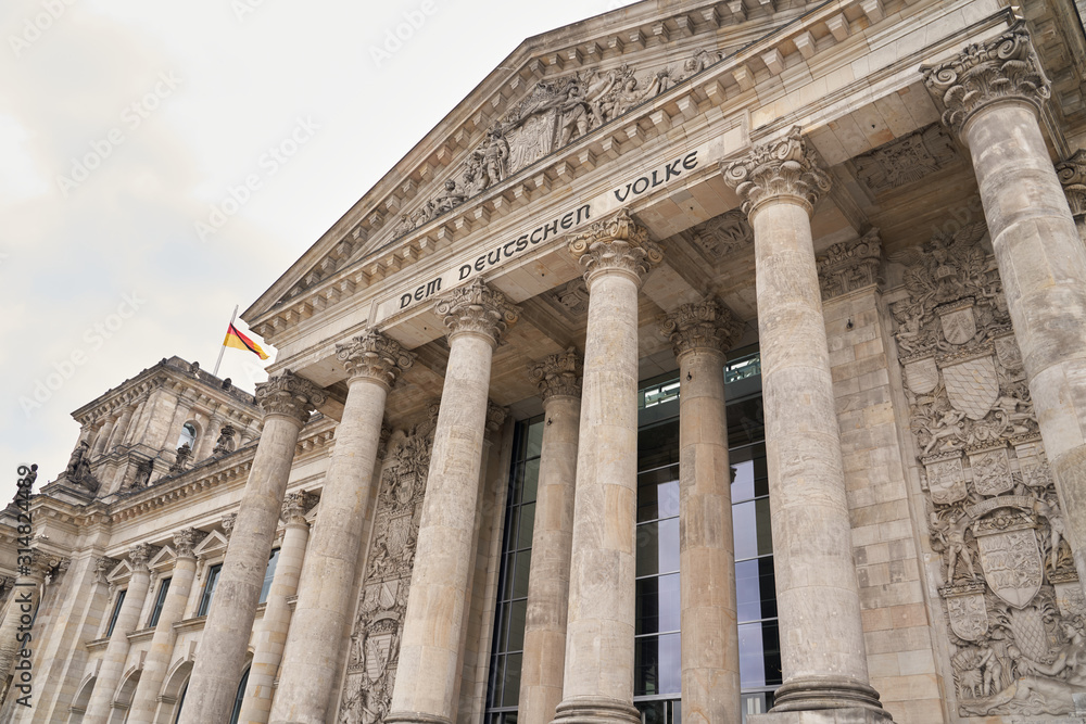 Reichstag building, seat of German Parliament (Deutscher Bundestag). Horizontal photo of colorful clean European city of Berlin, daytime cloudy sky, month of may travel in tourist place