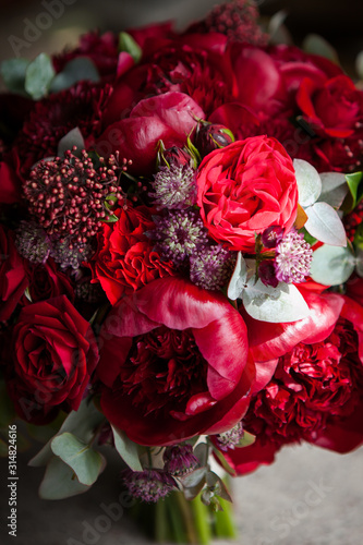 large buds of red roses in an expensive bouquet. close-up of a bouquet of huge red roses on a light background