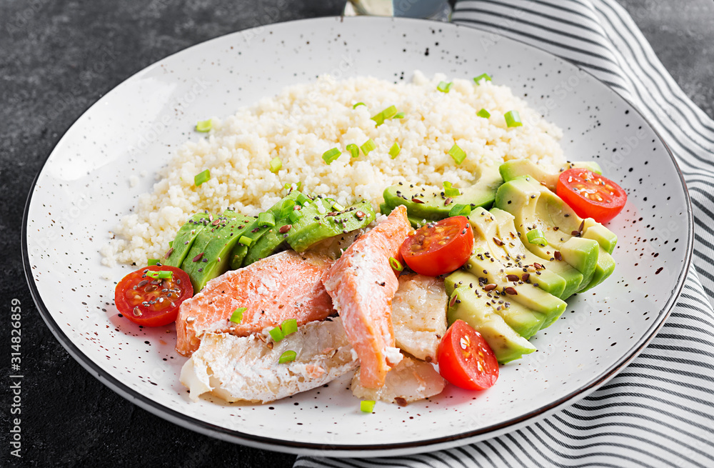 Healthy meal. Salad with salmon, couscous, avocado and tomatoes. Eastern oriental lunch Healthy meal. Salad with salmon, couscous, avocado and tomatoes. Eastern oriental lunch