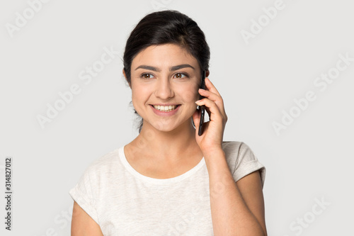 Happy smiling indian woman talking on mobile phone. © fizkes