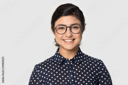 Head shot studio portrait indial girl wearing eyeglasses.