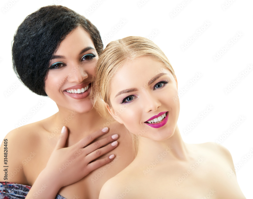 Women in love. Happy smiling aucasian blond girl and beautiful young girls posing in studio over white background. Fashion, beauty, glam, youth. Makeup. Double female portrait. Homosexual relationship Women in love. Happy smiling aucasian blond girl and beautiful young girls posing in studio over white background. Fashion, beauty, glam, youth. Makeup. Double female portrait. Homosexual relationship