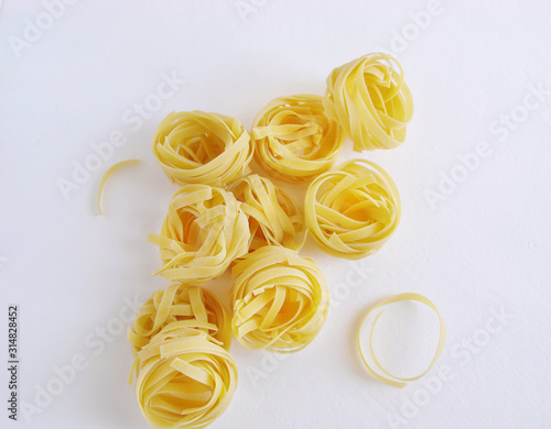 Tagliatelle pasta on a light background