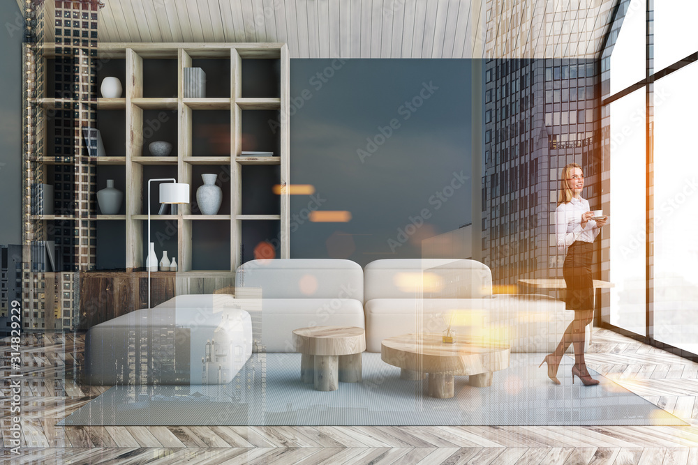 Woman in gray living room with bookcase
