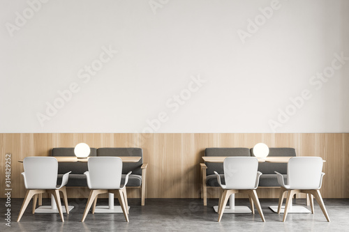 Modern white restaurant interior with armchairs