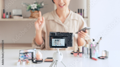Makeup Beauty fashion blogger recording video presenting cosmetics at home influencer on social media concept.