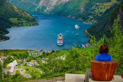 Tourist enjoying fjord Geiranger from viewpoint