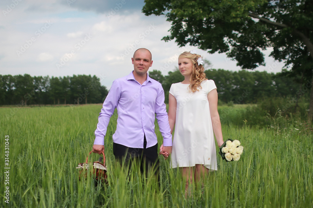 Couple lovers walking in field in summer day Couple lovers walking in field in summer day
