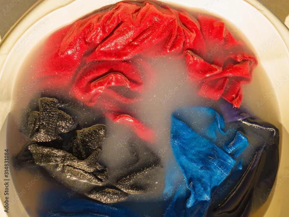 Fototapeta premium Soak cloth before washing outdoors