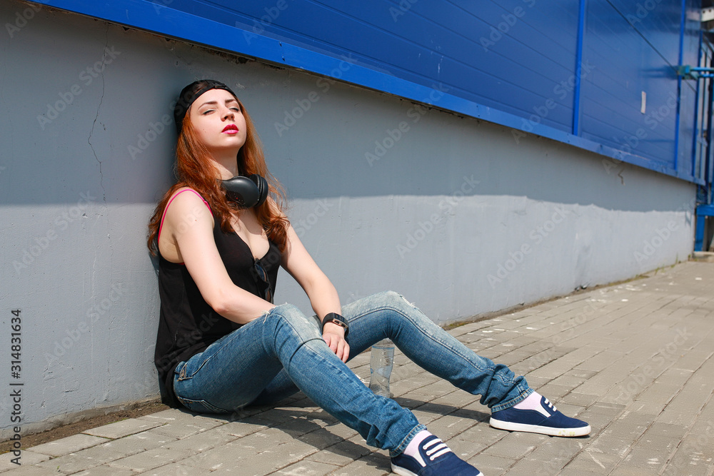 Girl hipster in a light hat and sunglasses on a summer Girl hipster in a light hat and sunglasses on a summer