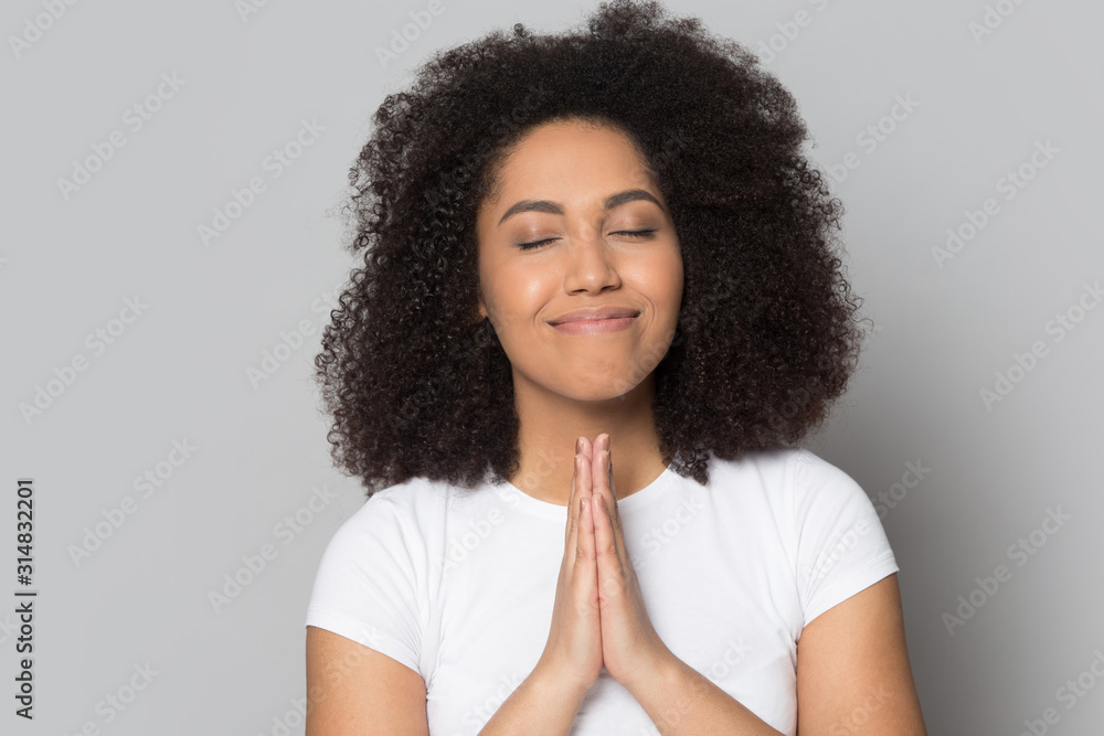 Mindful hopeful african american millennial woman praying, asking for help. Mindful hopeful african american millennial woman praying, asking for help.