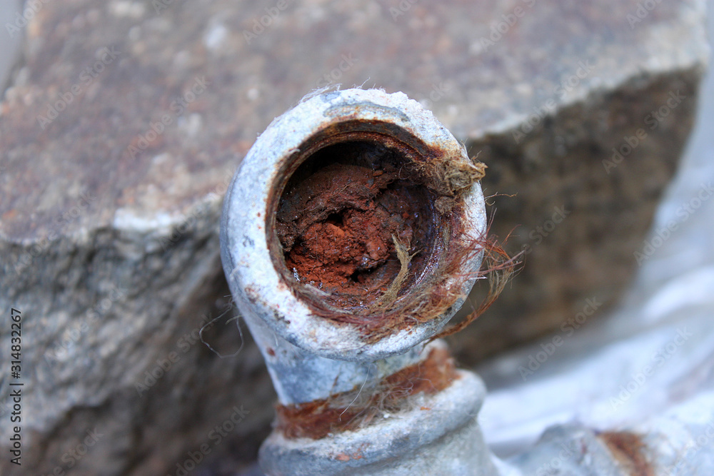 The detail of the old water pipe ingrown with rust. The pipe is full of it and the flow is limited. Needs reconctruction. 