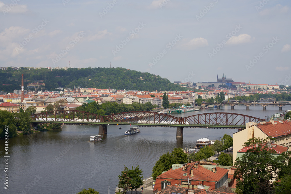 Top view of the wide Vltava river. Horizontal photo of colorful European city of Prague in Czech Republic daytime, cloudy sky, month of may, travel in tourist place.
