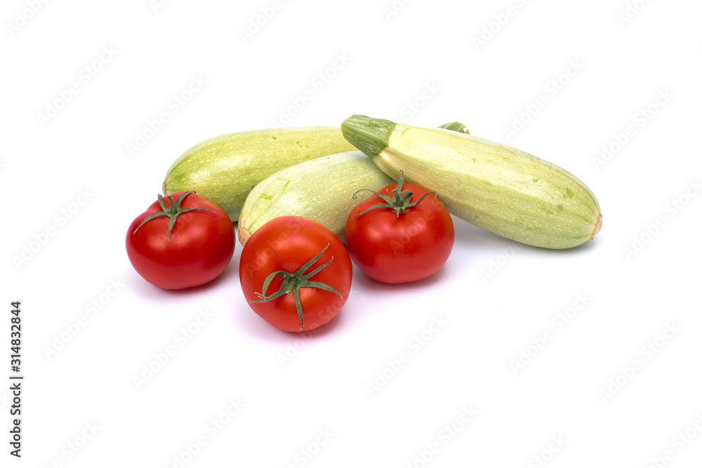 Zucchini with tomatoes isolated on white background. Fresh vegetable on white background. Tomatoes , zucchini, on isolated white background. Zucchini with tomatoes isolated on white background. Fresh vegetable on white background. Tomatoes , zucchini, on isolated white background.
