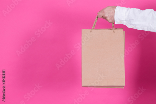 man holding recycled brown bag