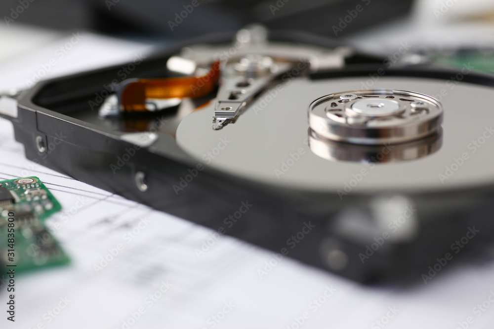 Hard drive from computer or laptop lies on the table in the repair shop. Performs fault diagnostics and performs urgent repairs recovery of lost data during deletion HDD closeup