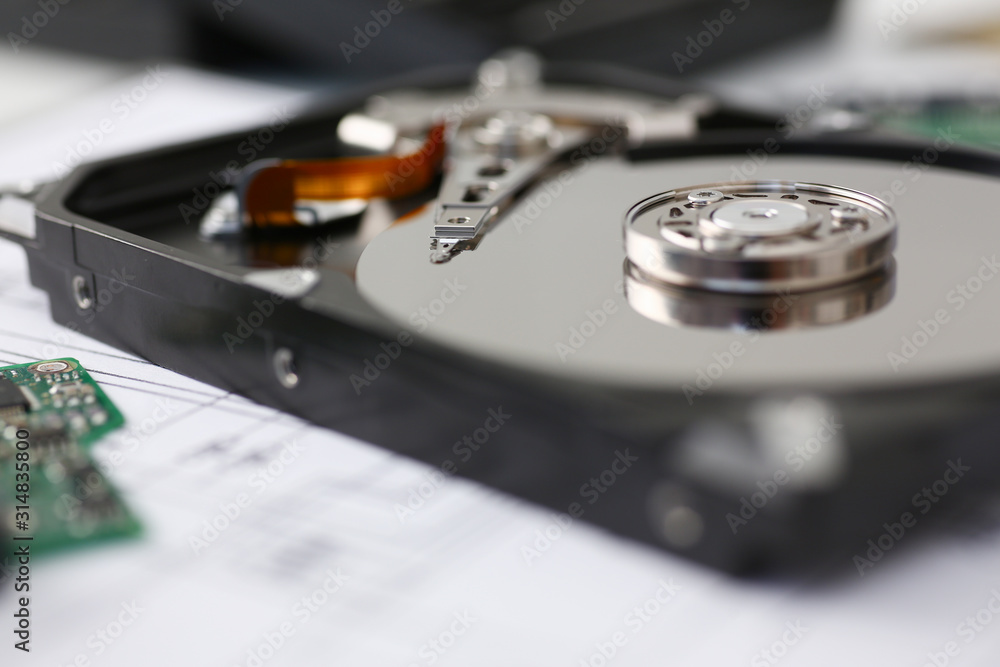 Hard drive from computer or laptop lies on the table in the repair shop. Performs fault diagnostics and performs urgent repairs recovery of lost data during deletion HDD closeup Hard drive from computer or laptop lies on the table in the repair shop. Performs fault diagnostics and performs urgent repairs recovery of lost data during deletion HDD closeup