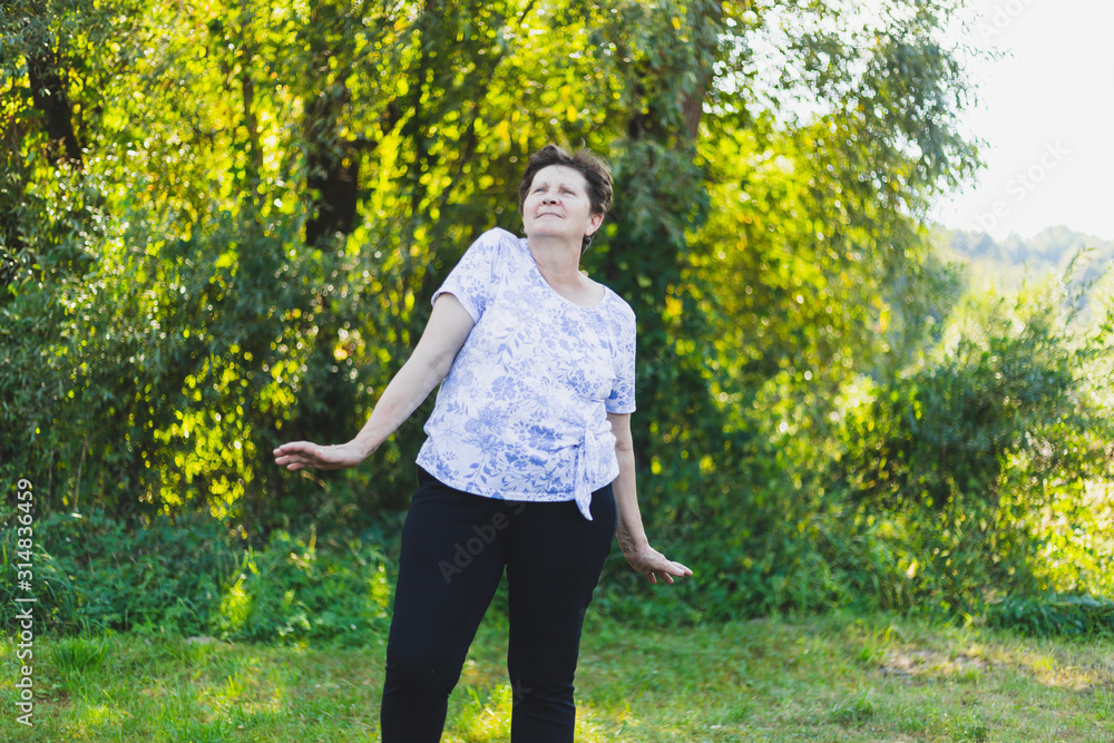 Senior woman dancing outdoors Senior woman dancing outdoors