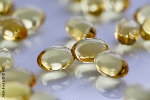 Tablets scattered yellow fish oil on table of the pharmaceutical laboratory pill for the prescription and treatment of various diseases chemistry