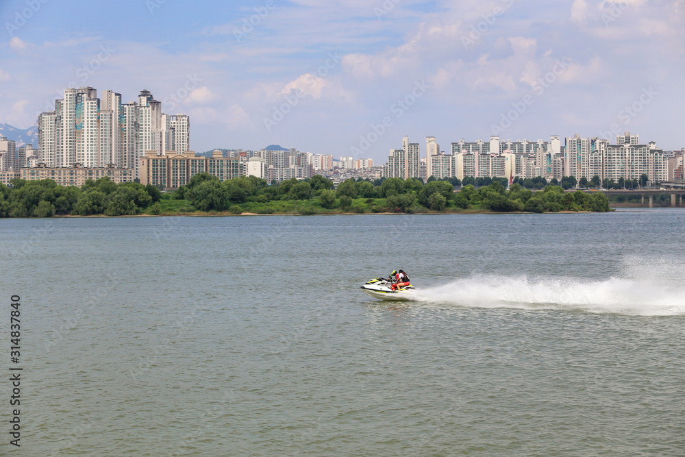 Fototapeta premium The man is enjoying the scooter at hanriver south korea;