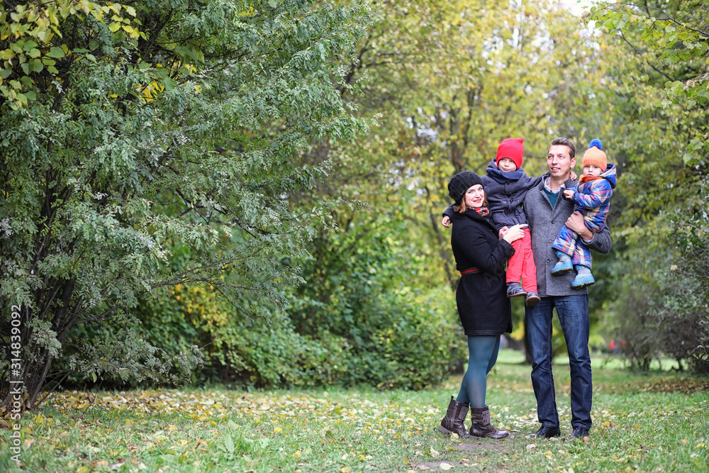 Fototapeta premium Young family with children on a walk