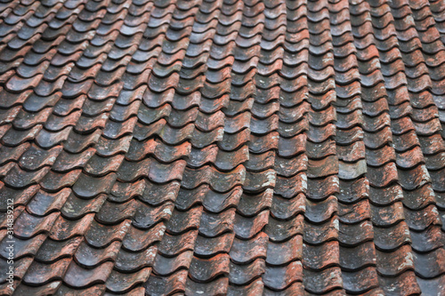 Red, orange, old countryside house roof pattern texture. © Artūrs Stiebriņš