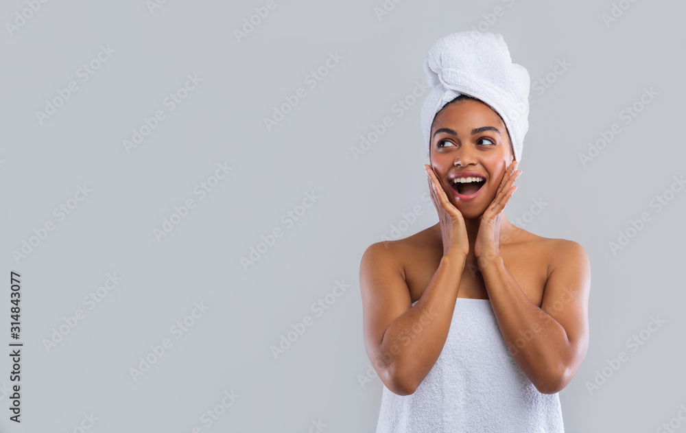 Shocked afro girl in towels looking at free space Shocked afro girl in towels looking at free space