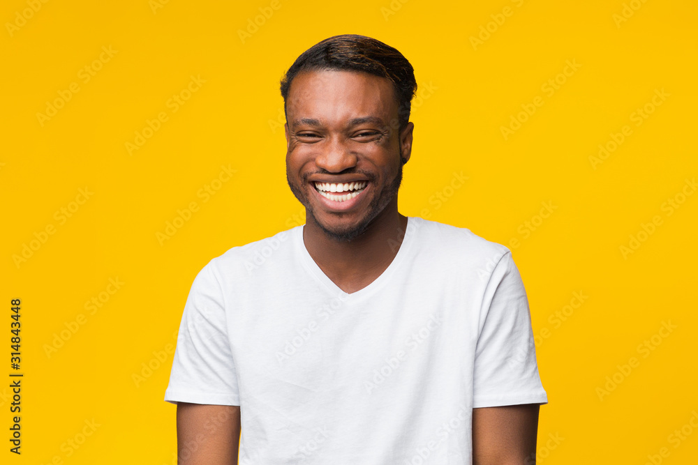 Funny Afro Man Laughing Looking At Camera Standing, Yellow Background Funny Afro Man Laughing Looking At Camera Standing, Yellow Background