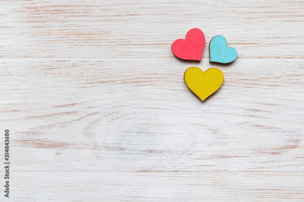 Red wooden hearts on wooden board. Valentines day vintage background. Valentine's Day concept Red wooden hearts on wooden board. Valentines day vintage background. Valentine's Day concept