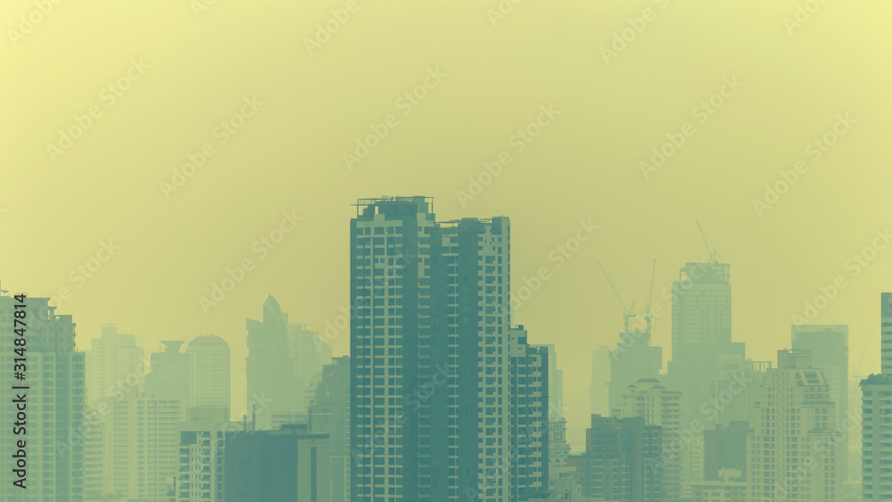 cityscape of high rise buildings in poor weather morning, haze of pollution covers city, global warming concept