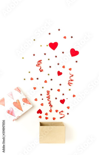 Valentine's day background.  gift box with various party confetti, red hearts...