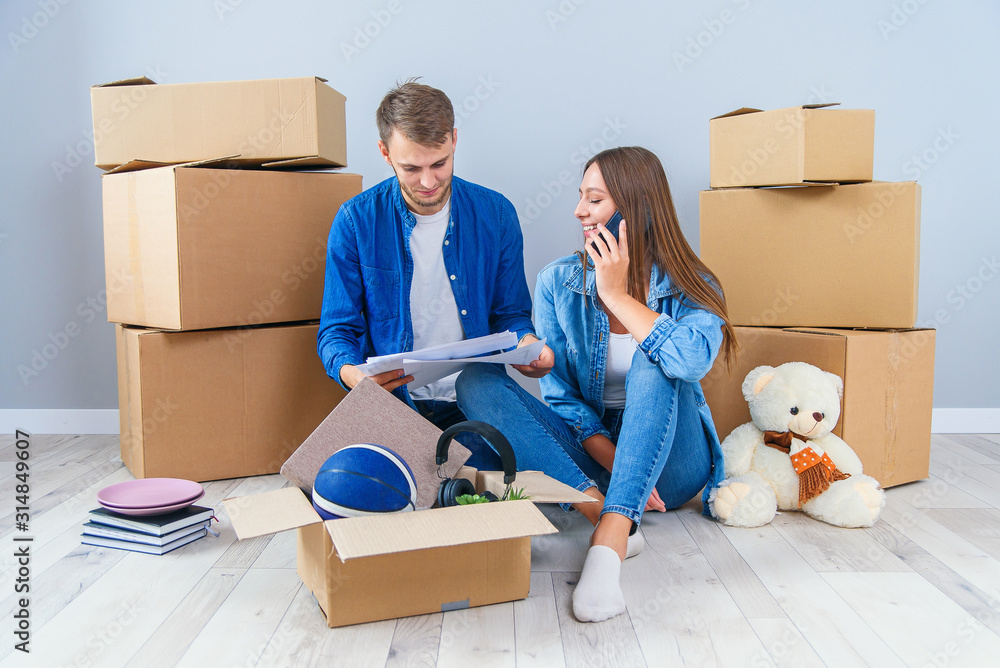 Caucasian pleasant young couple in love looking at the visualisation of their home interior design. Caucasian pleasant young couple in love looking at the visualisation of their home interior design.
